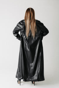 Back view of model wearing the Eclipse Trench showing the caped yoke detail across the shoulders
