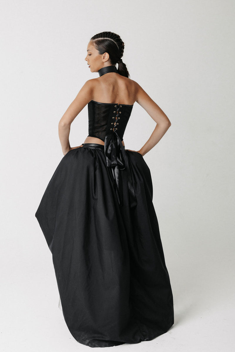 Back view of the Sisi Skirt showing its high low hem and gathered volume
