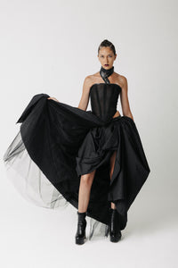 Front view of model wearing the Sisi Skirt, a voluminous ball gown skirt with a cactus leather waistband, styled with a corset top