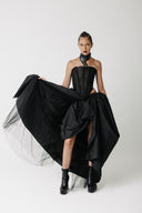 Front view of model wearing the Sisi Skirt, a voluminous ball gown skirt with a cactus leather waistband, styled with a corset top