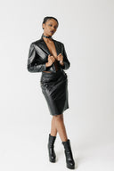 Front view of model wearing the Cinder Blazer, a cropped cactus leather blazer, open over a spiked leather skirt sold separately