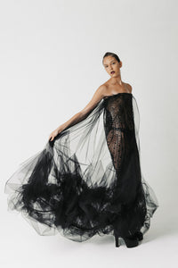 The Hatshepsut Gown side view showing the sheer tulle cape trailing from the shoulder into a voluminous pooled hem
