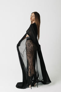 The Somber Top side view showing the cape sleeve movement and cropped length