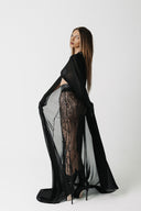 The Somber Top side view showing the cape sleeve movement and cropped length