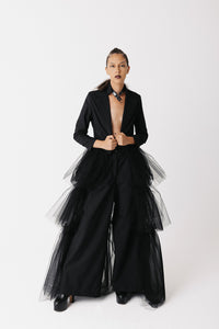 Model wearing The Boleyn Jacket, a cropped cotton jacket with tiered eco-tulle train, front view